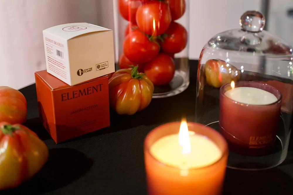 Jardín Azteca candles and boxes surrounded by heirloom tomatoes